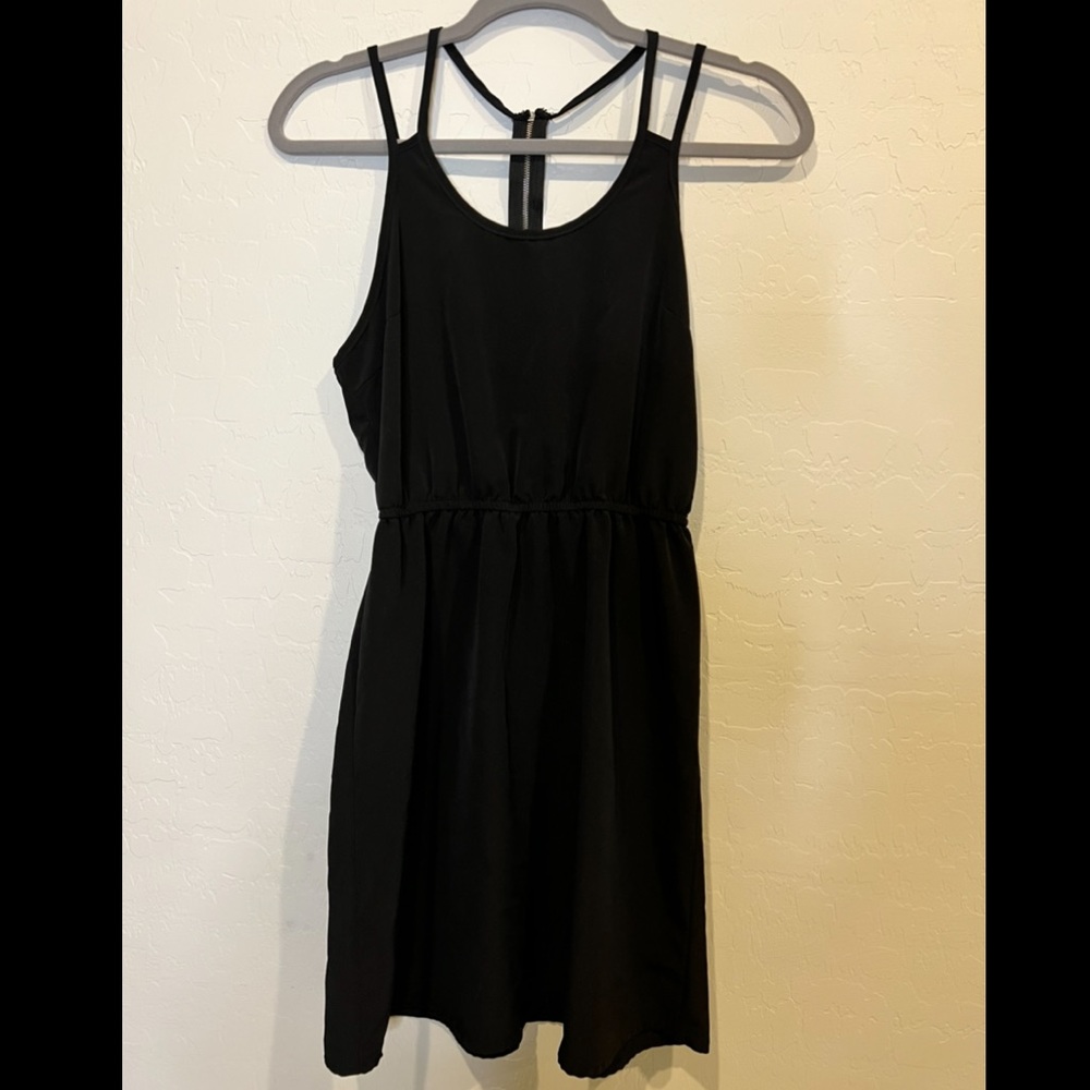 Black dress with spaghetti straps.